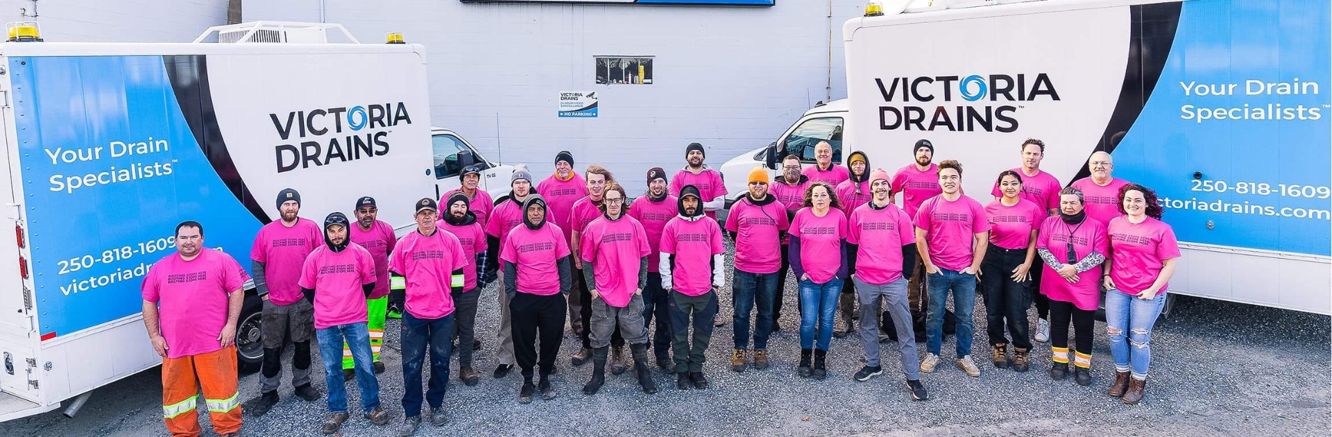Staff of Victoria Drains standing outside wearing Pink Shirts for anti-bullying day