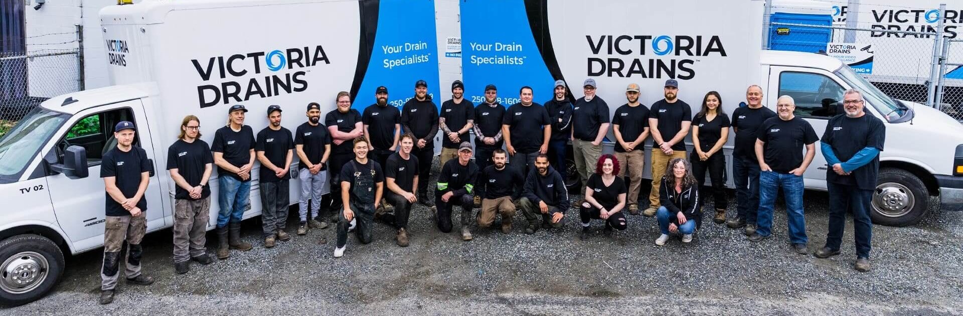 Victoria Drains staff standing in front company trucks